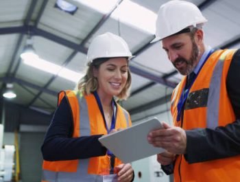 Shot of two engineers using a digital tablet together in an industrial place of work